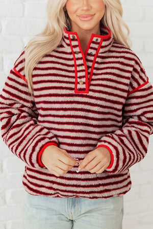 beige sweatshirt featuring pocketed and striped