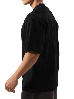Black washed cotton t-shirt with boxy cut and short sleeves on a model.