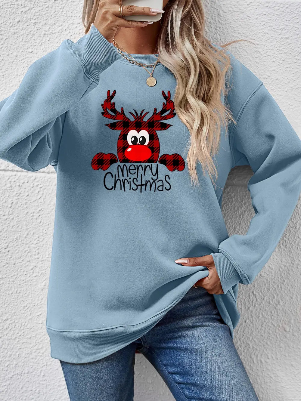 Light blue crewneck sweatshirt with plaid reindeer graphic and Merry Christmas text.