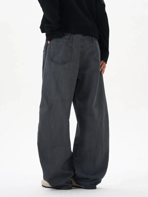 Men's oversized grey cargo pants with a relaxed fit and back pockets.