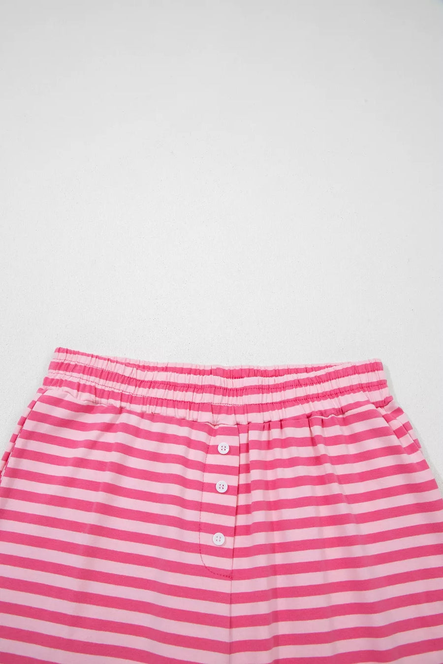 Pink and light pink striped cotton shorts with elastic waist and button detail