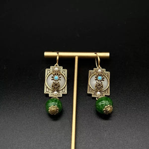 Vintage dangle earrings in gold-plated with dark green beads and white stone accents.