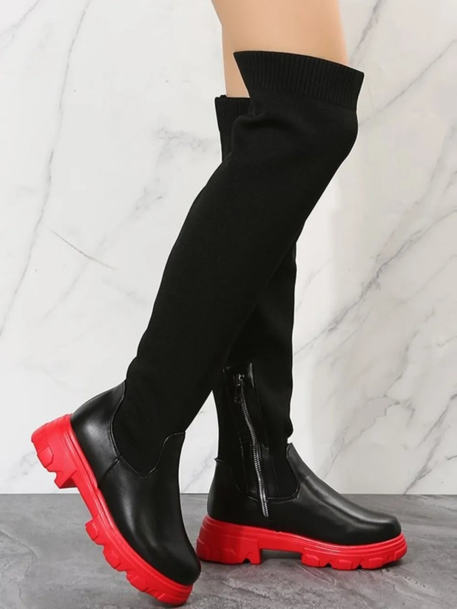 Black knit-top over-the-knee boots with red platform soles and side zippers.