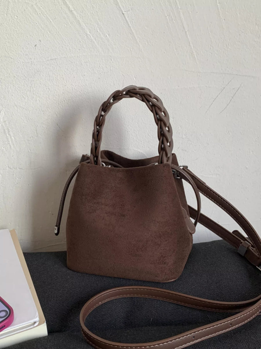 Brown suede mini crossbody bag with braided handle and adjustable strap