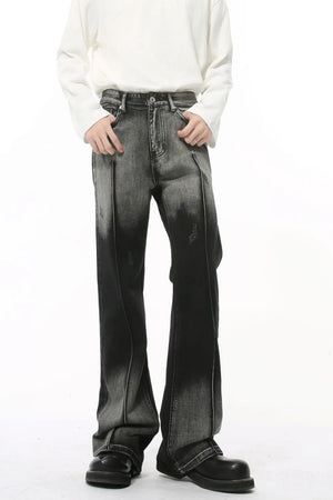 Faded flare denim jeans in dark with front pleat detail and distressed accents.