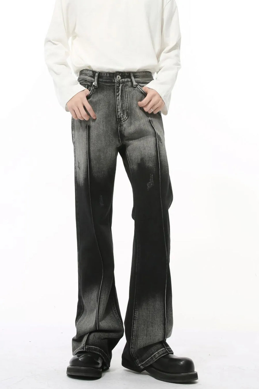Faded flare denim jeans in dark with front pleat detail and distressed accents.