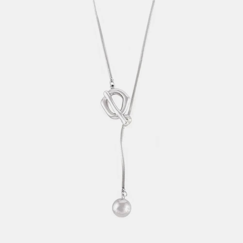 Silver lariat necklace with toggle clasp and dangling ball pendant