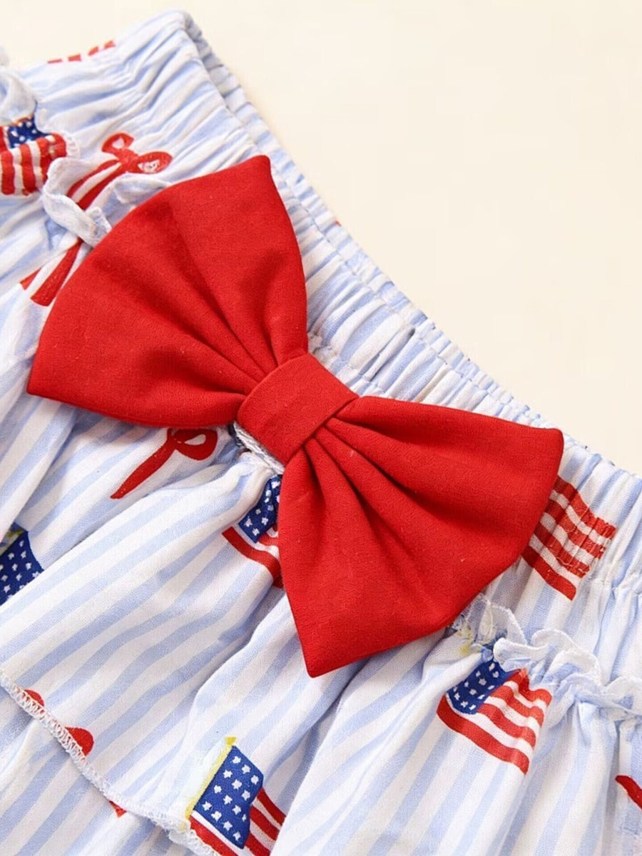 Baby set with blue stripes, American flag print, and red bow detail.