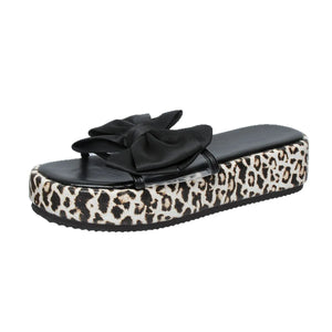 Leopard print platform slides with black bow detail.
