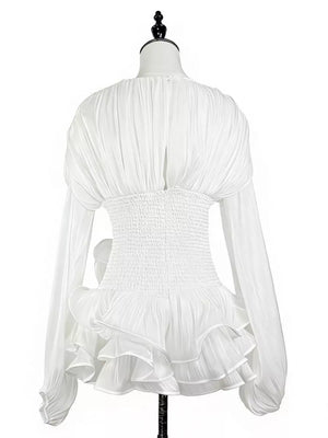 White cotton mini dress with ruched bodice, corset waist, and ruffled hem.