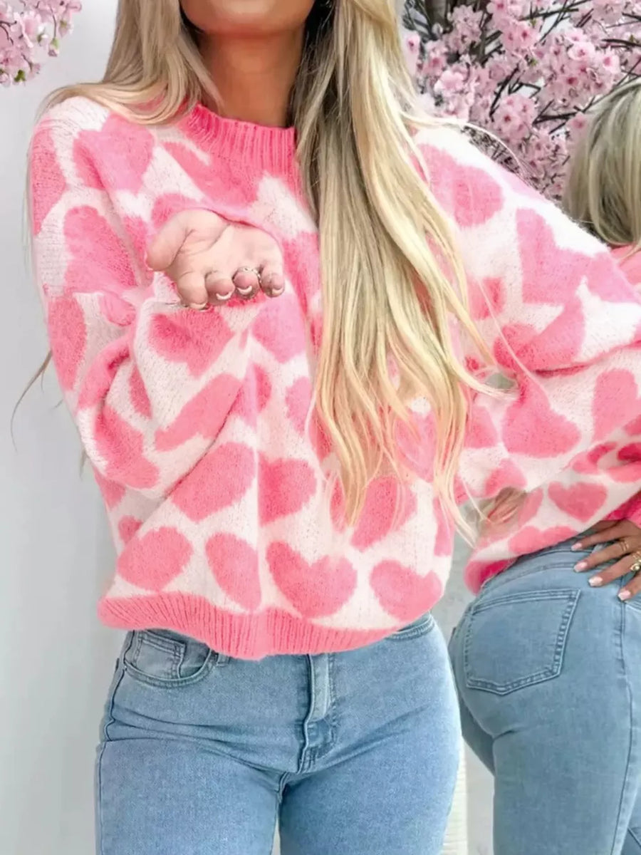 Charming heart pattern knit sweater in blush pink acrylic with crew neck and long sleeves.