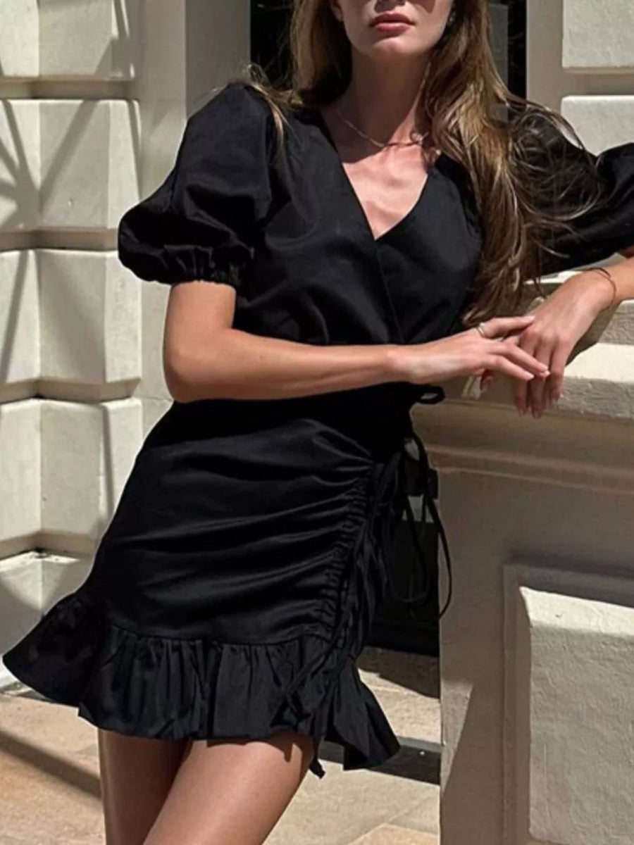 Black puff sleeve wrap dress with ruched side and ruffled hem