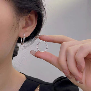 Silver earrings featuring twisted design and twisted