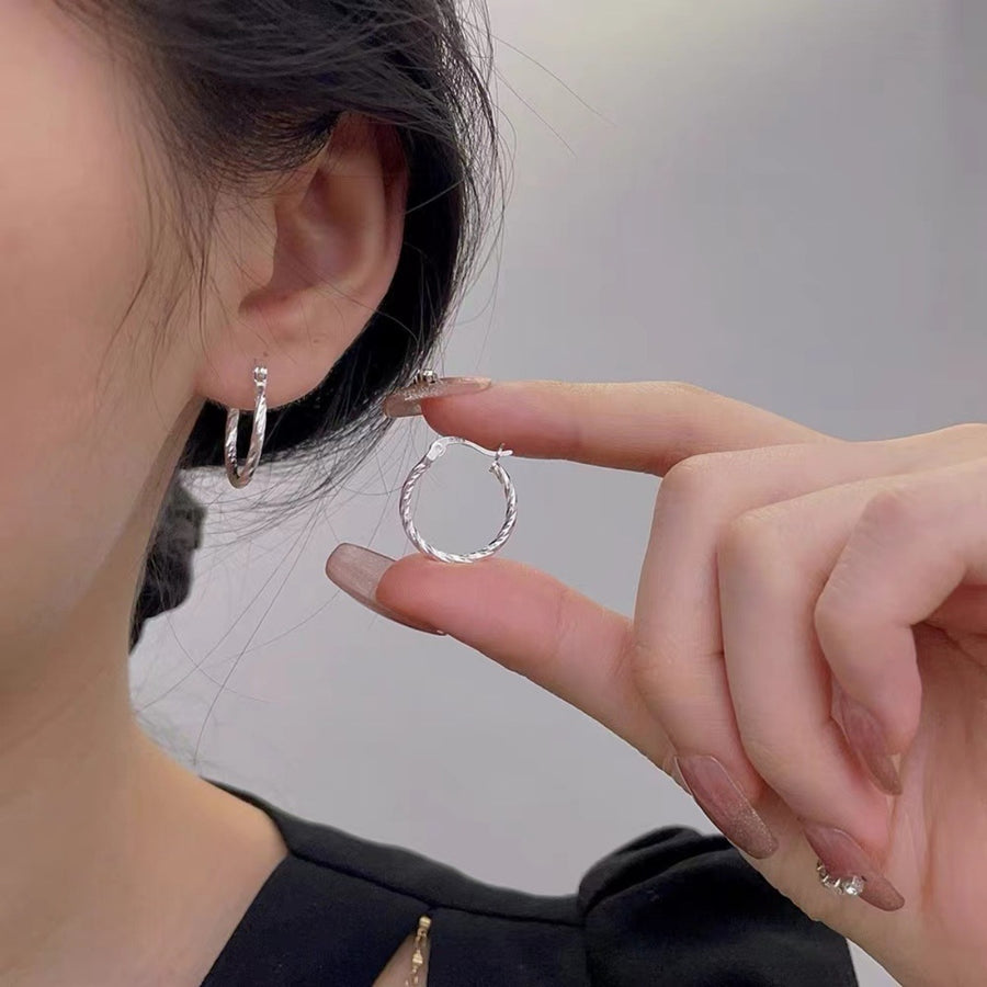 Silver earrings featuring twisted design and twisted