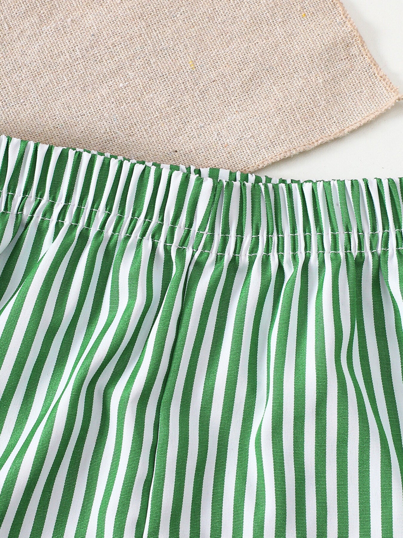 Light green and white striped baby shorts with elastic waistband