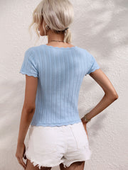 Light blue knit top with scalloped neckline and hem, featuring a textured pattern.