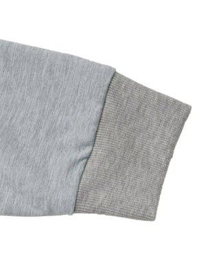 Gray sweatshirt sleeve detail with ribbed cuff and contrasting fabric texture.