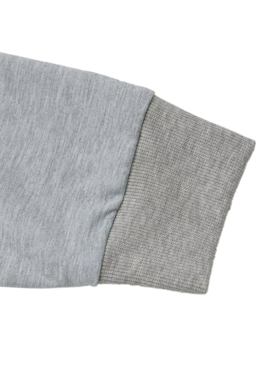 Gray sweatshirt sleeve detail with ribbed cuff and contrasting fabric texture.