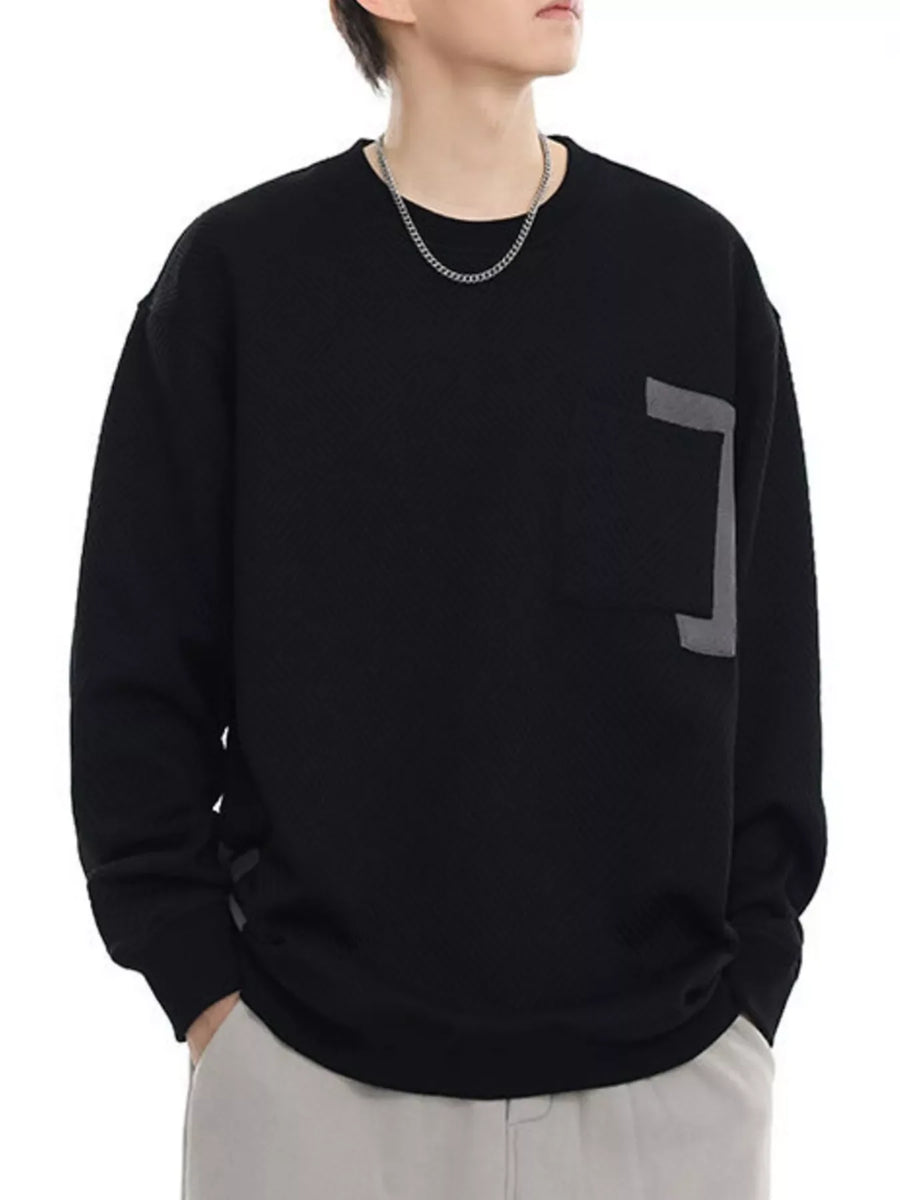 Black crew neck sweatshirt with textured fabric and a grey accent on the chest.
