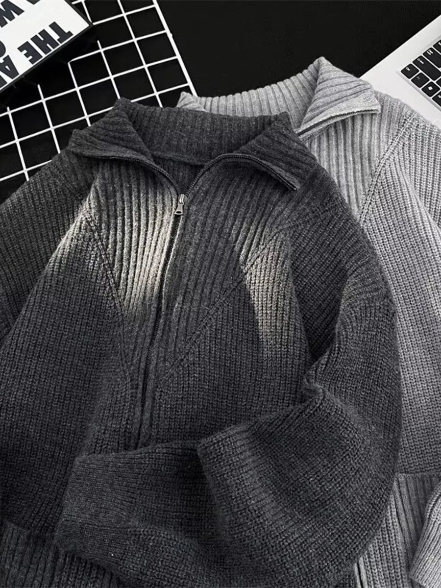 Ribbed zip-up knit cardigan in dark gray with a collared neckline and a silver zipper.