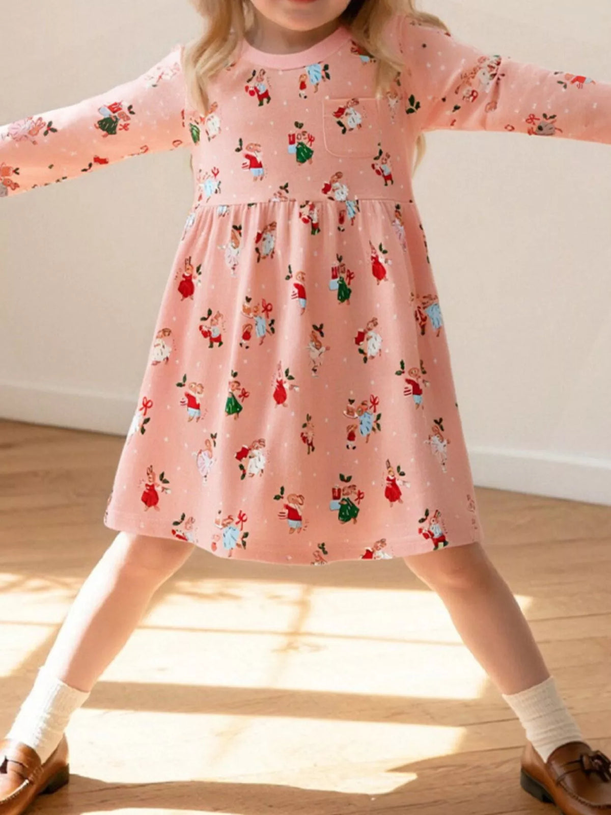 Baby girls' pink cotton Christmas print dress with long sleeves and a pocket.