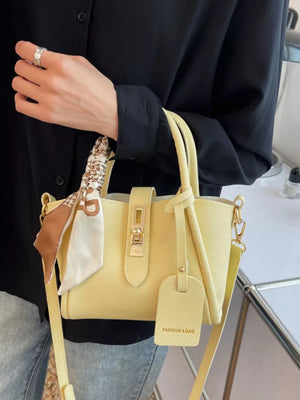 Yellow mini crossbody bag with scarf detail and gold hardware