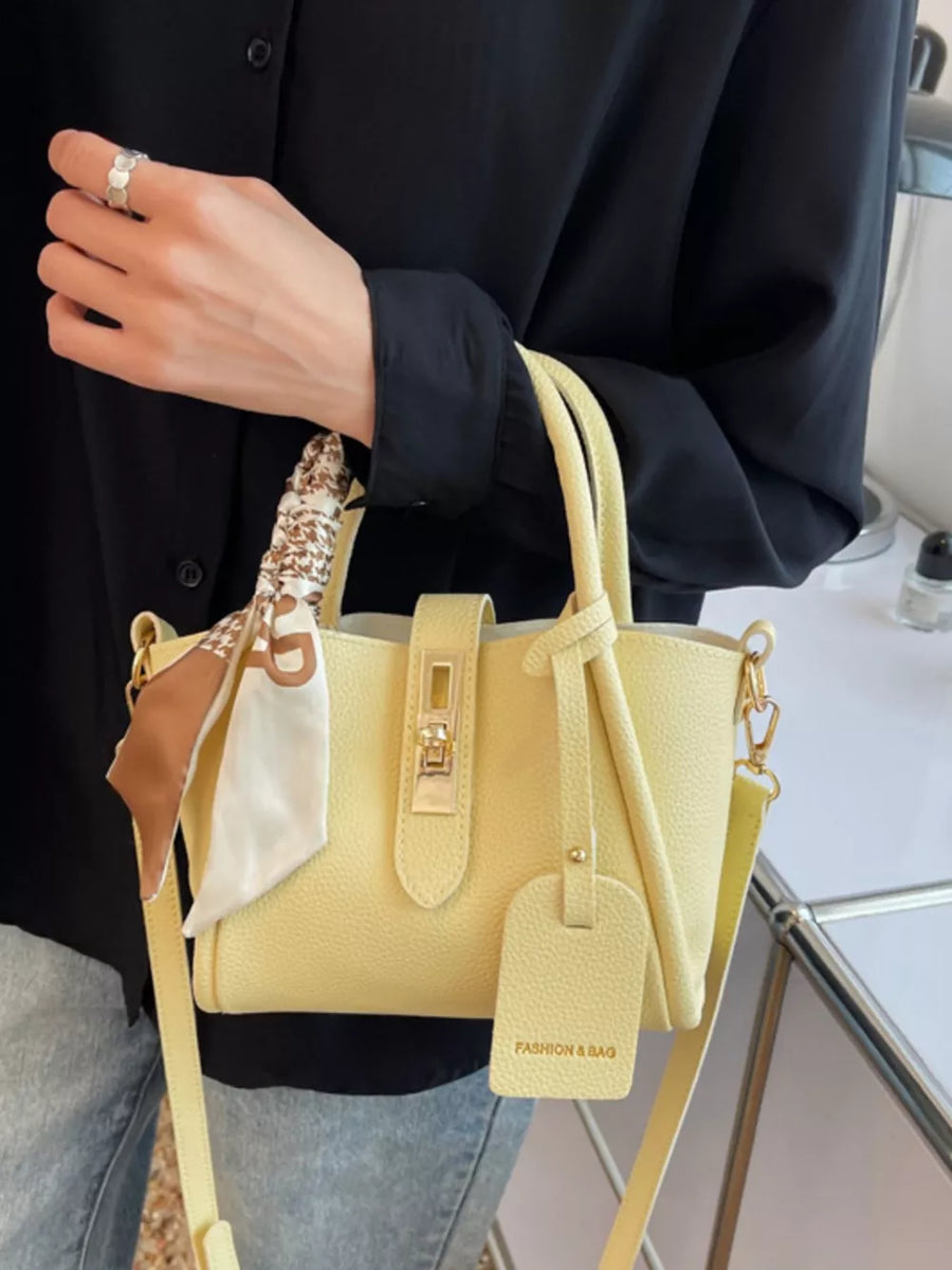 Yellow mini crossbody bag with scarf detail and gold hardware