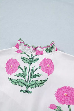 Vibrant floral mini dress with pink ruffled neckline and green trim.
