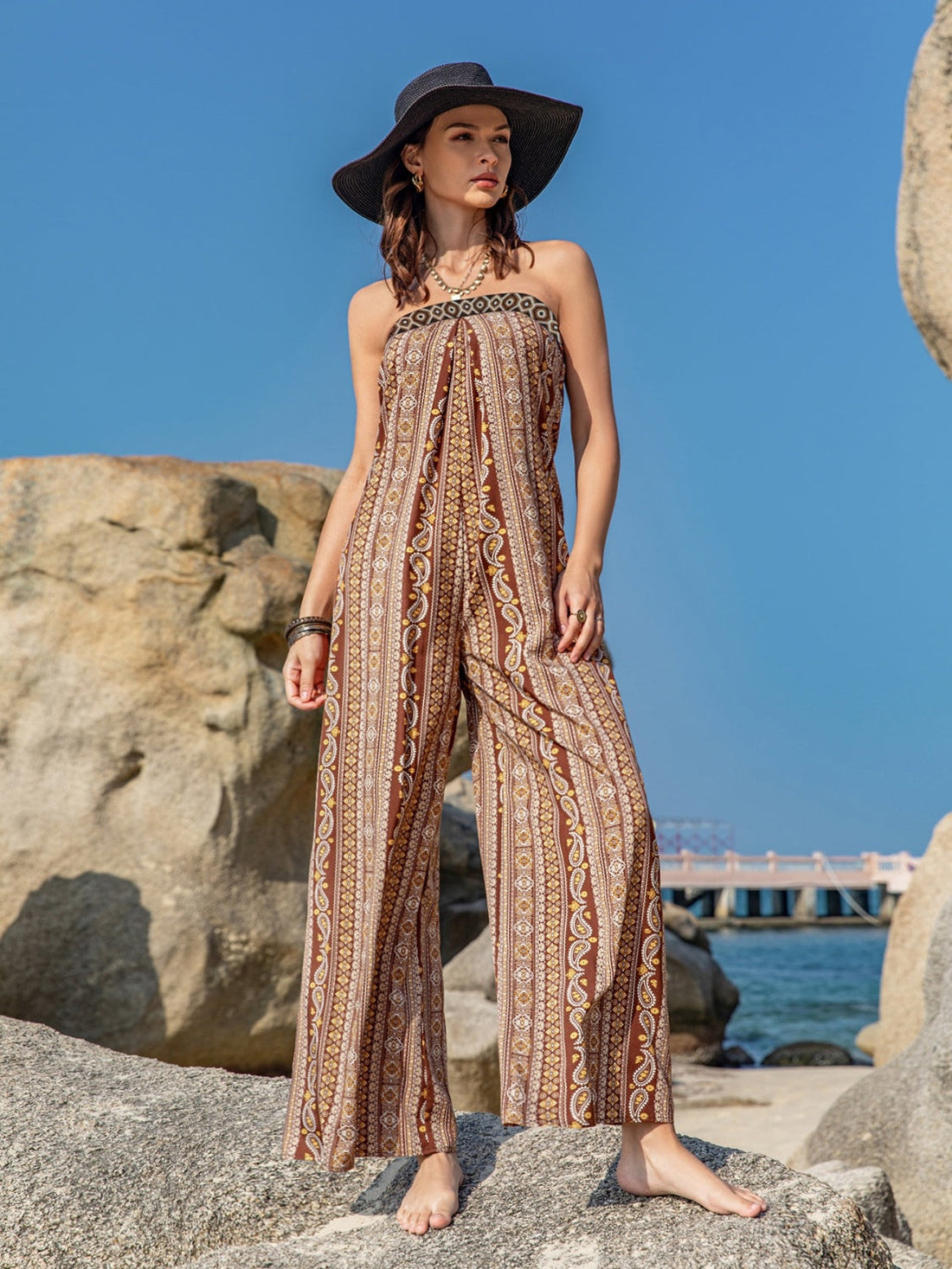 Boho bandeau jumpsuit in brown with a floral paisley print and wide legs.