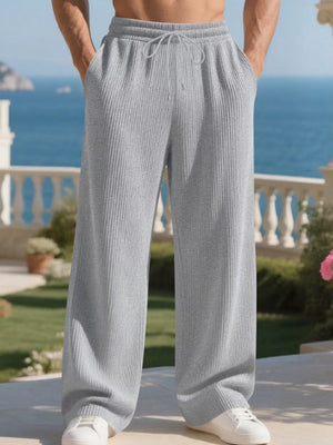 Light gray ribbed drawstring sweatpants with relaxed fit and pockets.