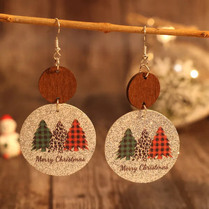 Festive tree print drop earrings with wood accents and Merry Christmas text.