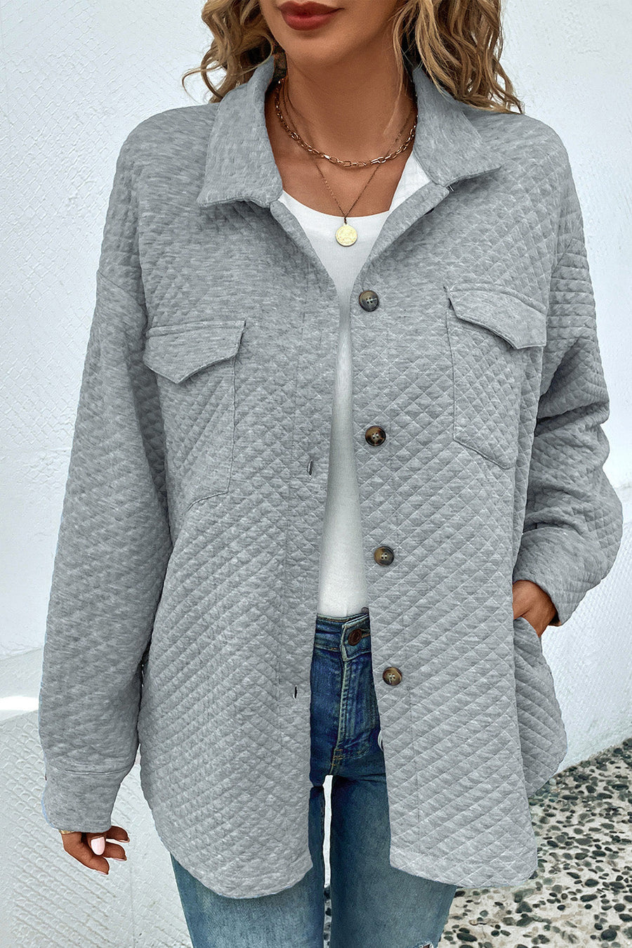 Quilted overshirt in grey with patch pockets and button front, styled casually.