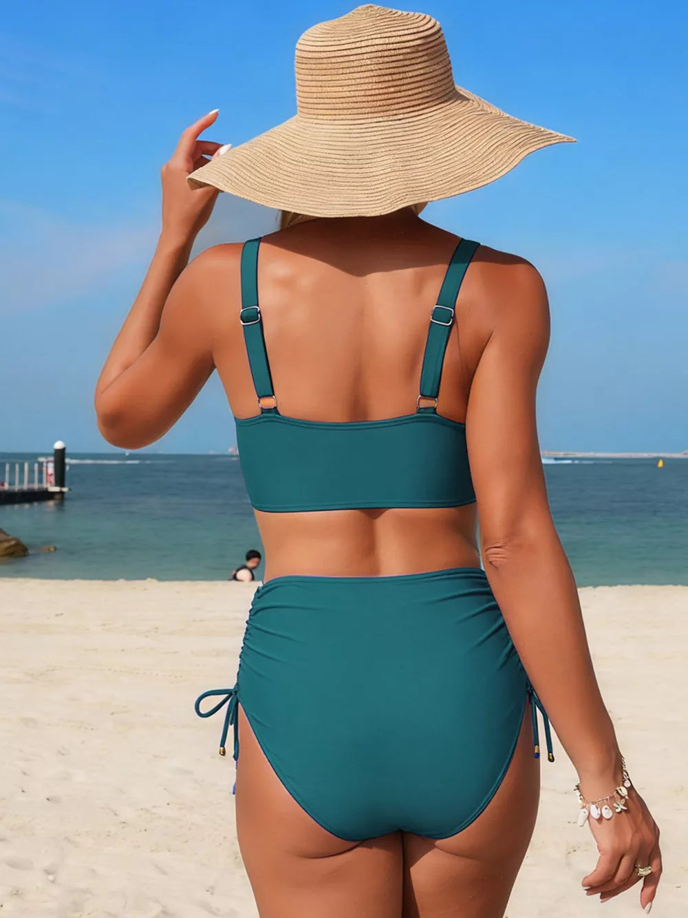 Teal high-waisted bikini bottoms with drawstring sides and a matching bikini top.