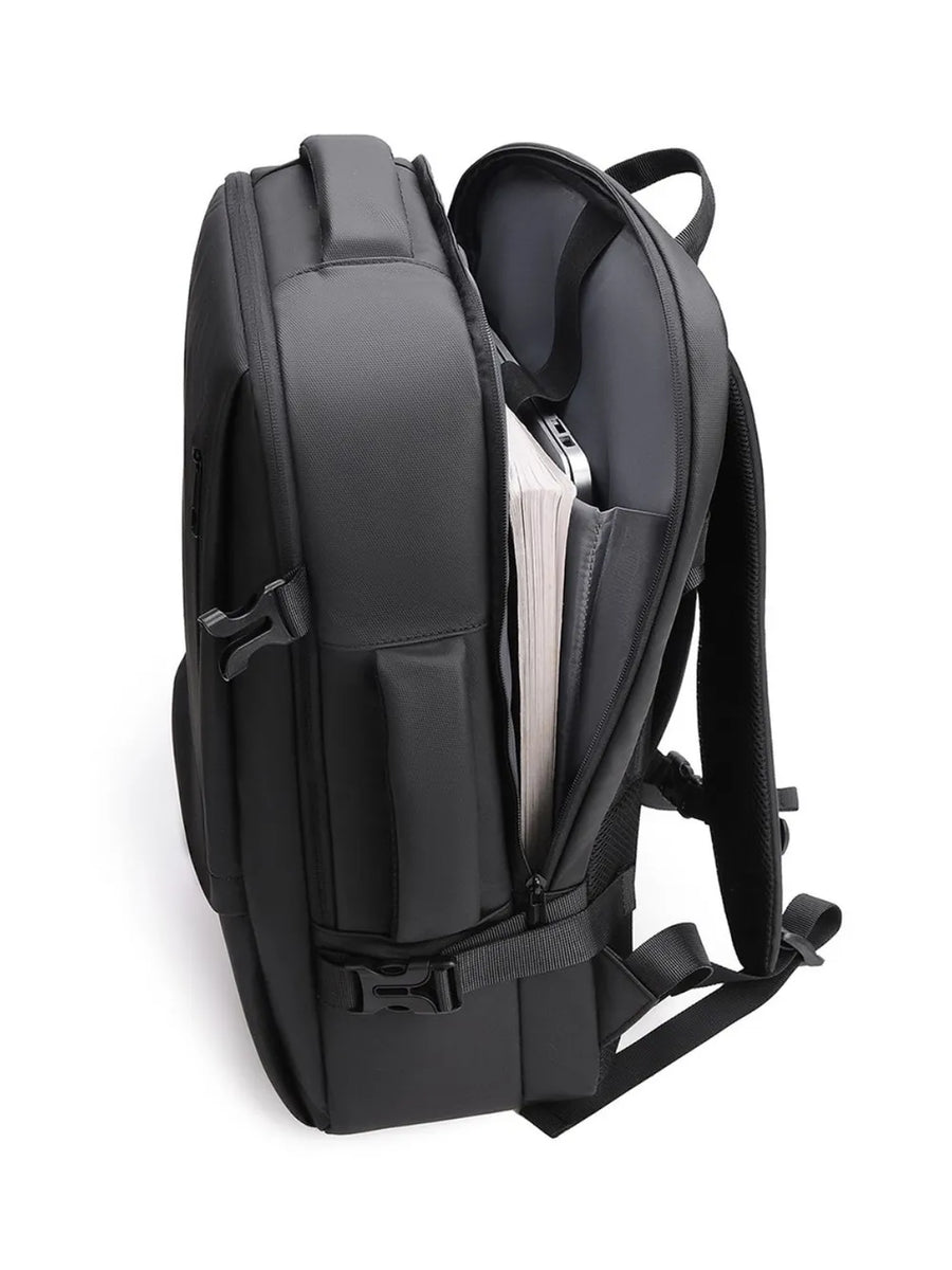 Black convertible commuter backpack with open main compartment showing books and laptop.