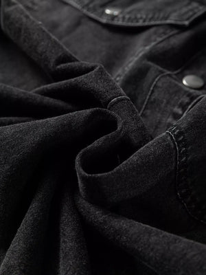 Black denim button-up dress with raw hem detail and button closure.