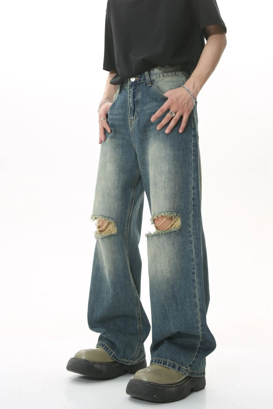 Distressed knee rip wide-leg jeans in medium wash denim with a relaxed fit.