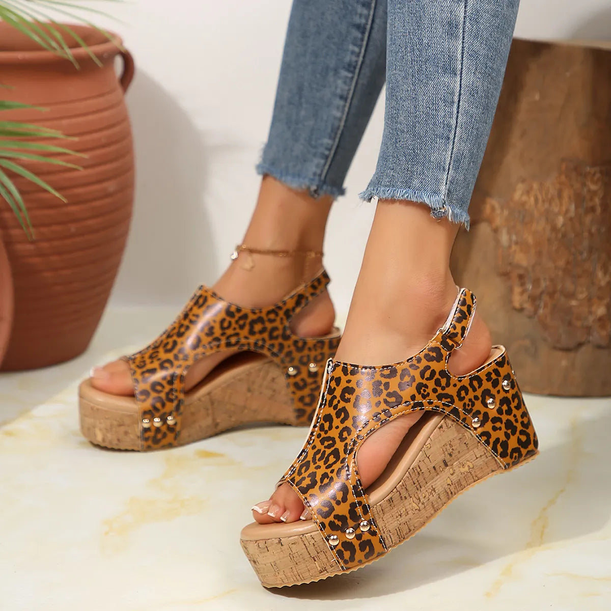 Leopard cutout cork wedge sandals with gold stud details in caramel color.