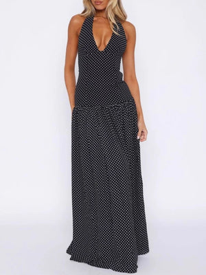 Black polka dot halter neck maxi dress with a deep V-neck and tiered skirt.