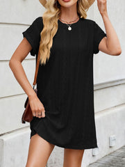 Black eyelet mini dress with crew neck, short sleeves, and diamond pattern.