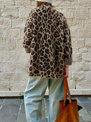 Leopard print cardigan with pockets and cuffed sleeves, worn casually.