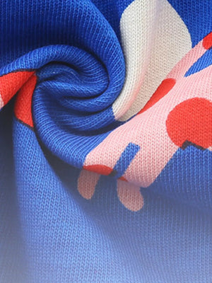 Toddler dress with blue, pink, and red polka dot pattern on cotton fabric.