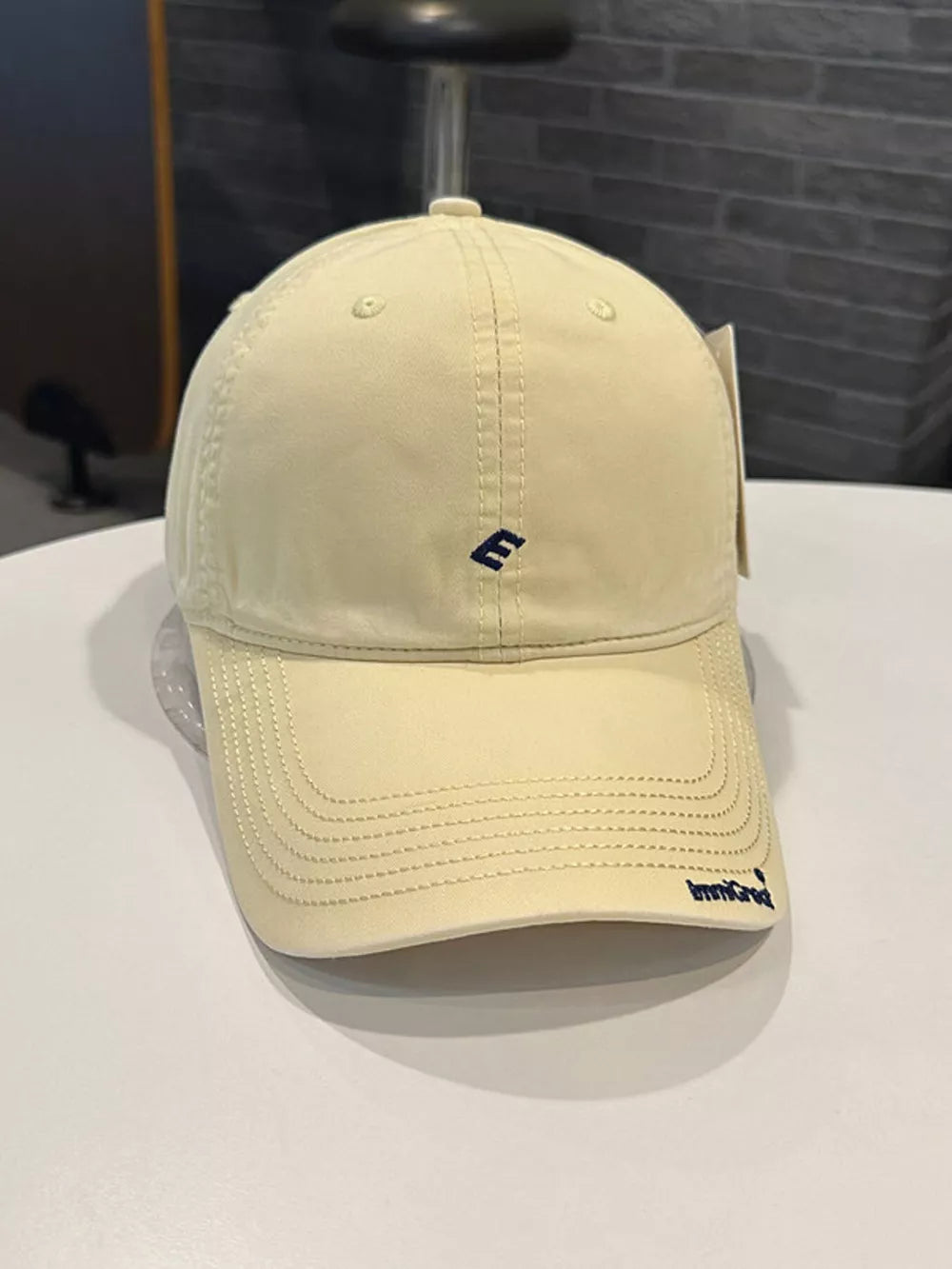 Yellow cotton baseball cap with embroidered E and curved brim
