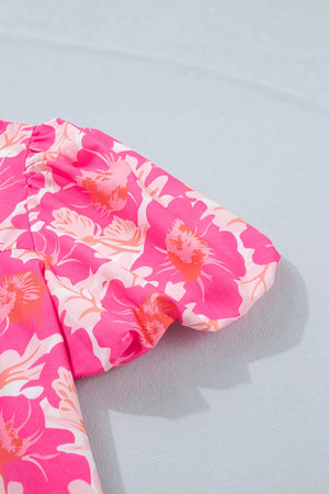 Vibrant floral print polyester blouse with bubble sleeves and ruffled detail.