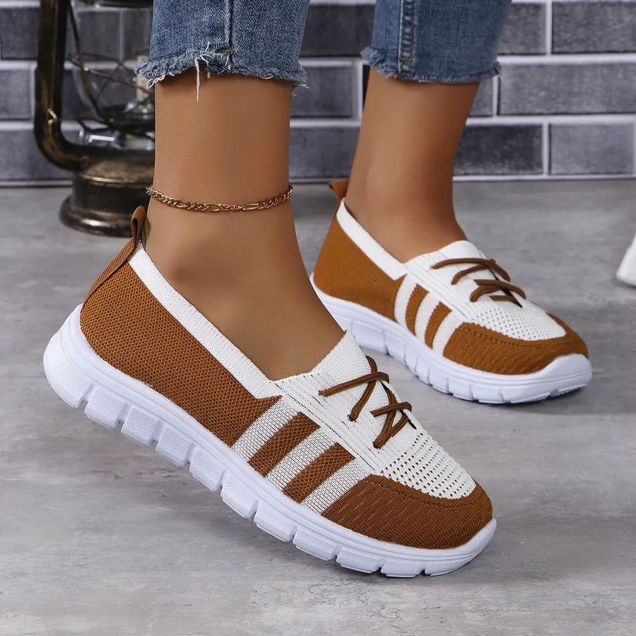 Brown and white breathable knit lace-up sneakers with striped accents.