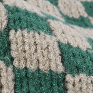 Checkerboard knit beanie in dark green and khaki with a textured stitch detail.