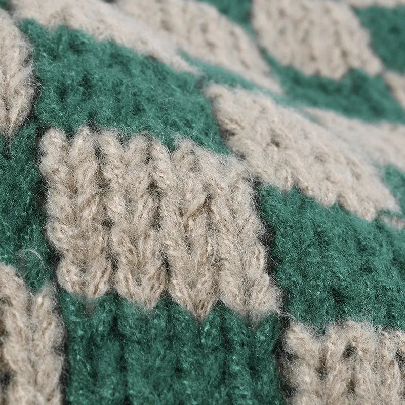 Checkerboard knit beanie in dark green and khaki with a textured stitch detail.
