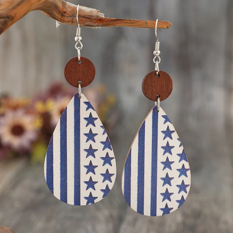 Patriotic print teardrop earrings with blue stars and white stripes, featuring wooden accents.