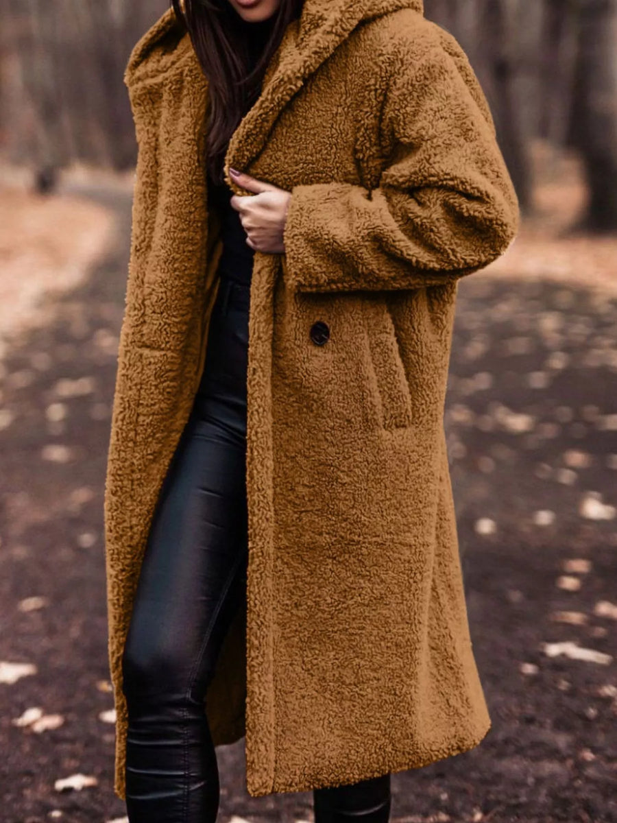 Brown teddy bear longline coat with hood and button closure, worn by a woman.