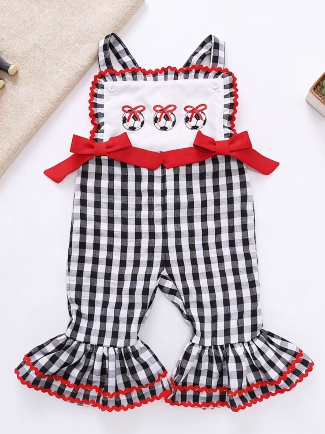Gingham soccer ball embroidered jumpsuit with red bows and ruffle bell bottoms