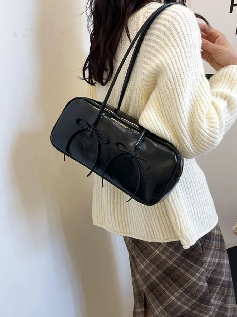 Black patent leather shoulder bag with double bow detail